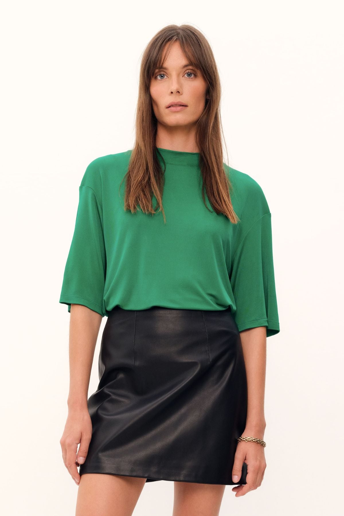 The grass green Aphrodite Top is constructed with luxurious silk viscose jersey, creating a relaxed tee silhouette with a high, round neckline. The silk knit fabric drapes with effortless grace.