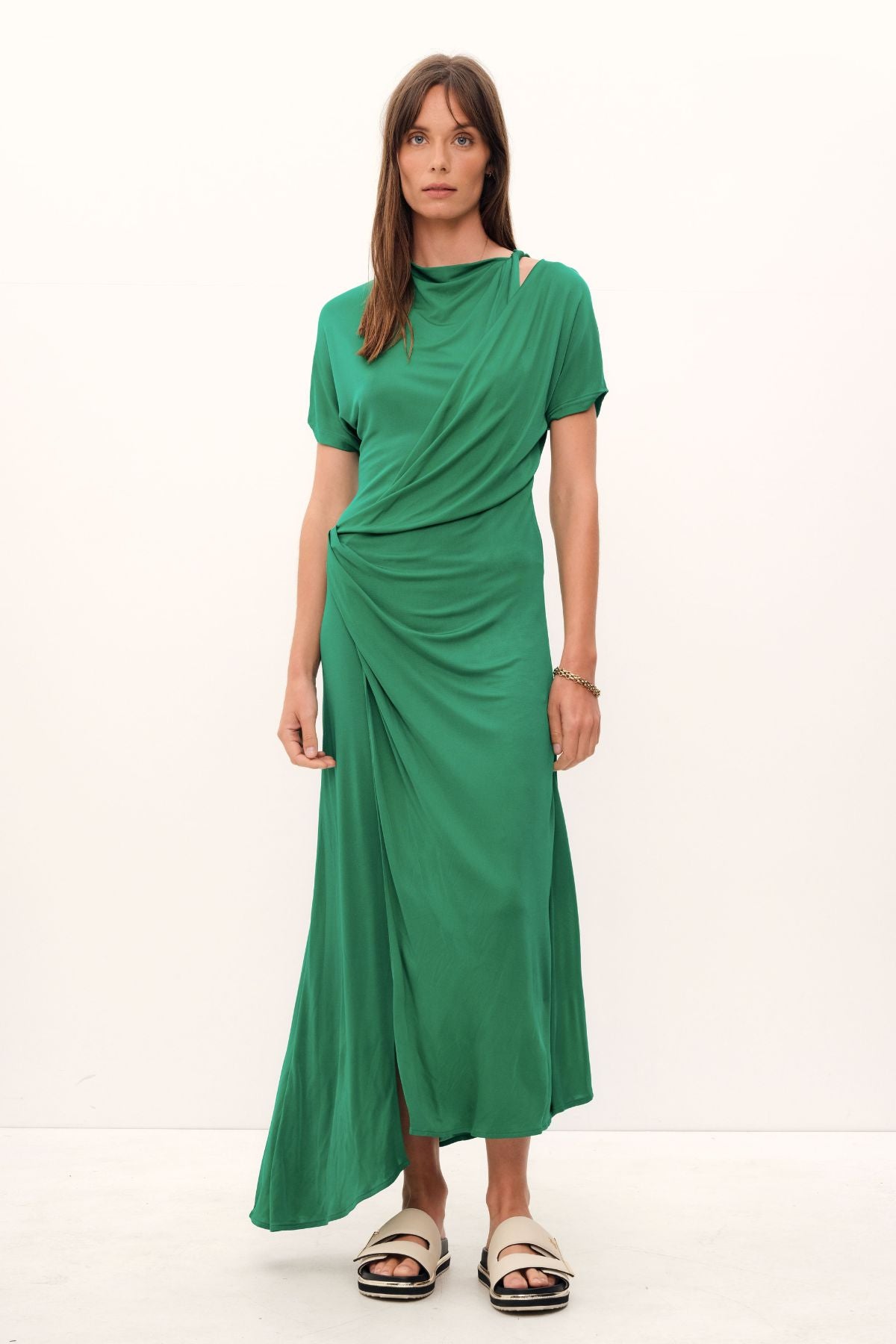 Exquisitely crafted from a luxe silk-viscose blend, the Aphrodite Draped Dress features a graceful silhouette defined by an asymmetric hem, gently tapered sleeves, and a flattering cinched waistline. Soft hues of grass and coco add an elegant touch.