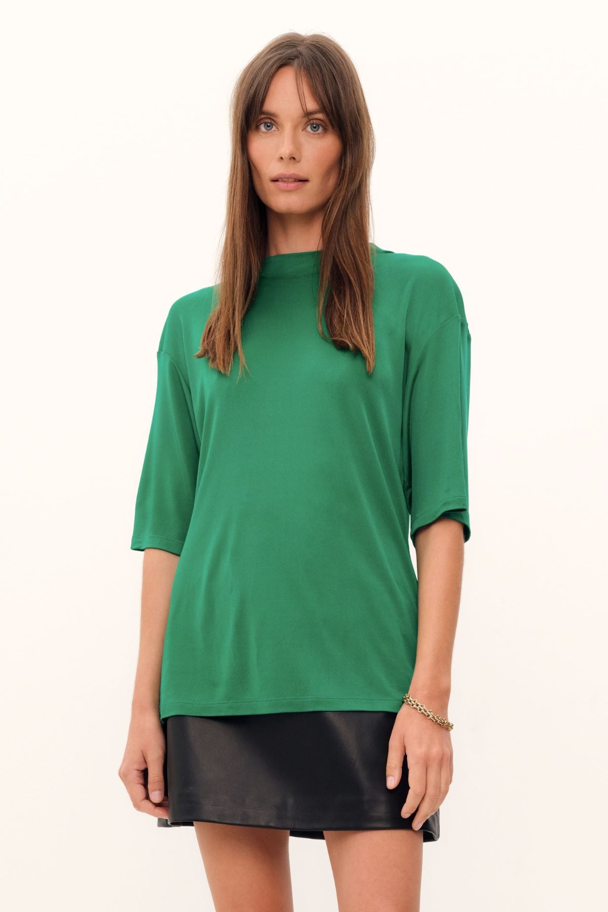 The grass green Aphrodite Top is constructed with luxurious silk viscose jersey, creating a relaxed tee silhouette with a high, round neckline. The silk knit fabric drapes with effortless grace.