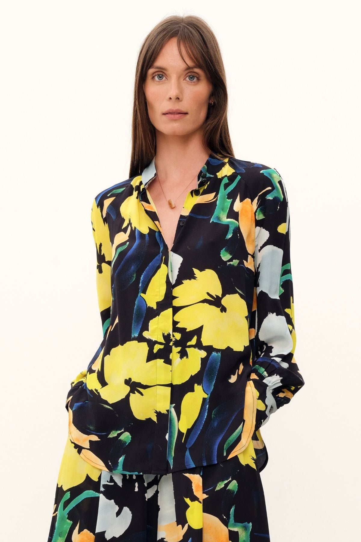 The Silk Hereafter Blouse by GINGER & SMART with a Artful floral print, pastel colors on rich navy base. Mandarin collar, concealed placket, full raglan long sleeve. Lightweight.