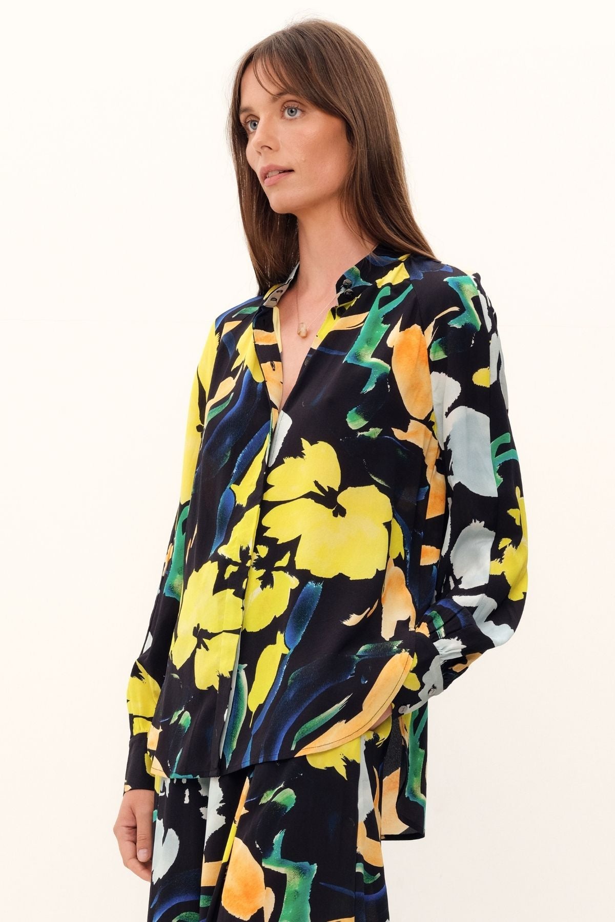 The Silk Hereafter Blouse by GINGER & SMART with a Artful floral print, pastel colors on rich navy base. Mandarin collar, concealed placket, full raglan long sleeve. Lightweight.