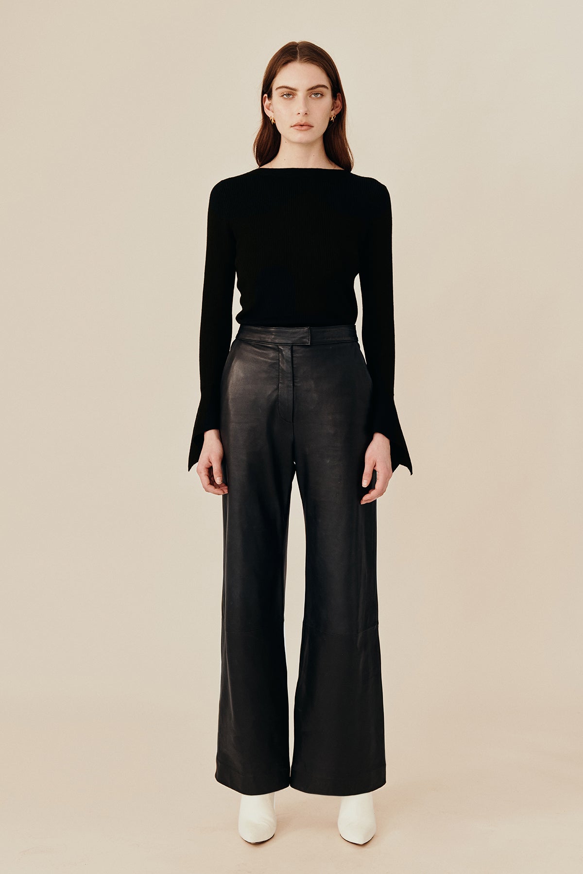 Model wearing Australian fashion designer Ginger & Smarts’ Genesis Leather Pant in a classic straight leg cut in luxe black leather worn with the black wool Dimension Knit Top.