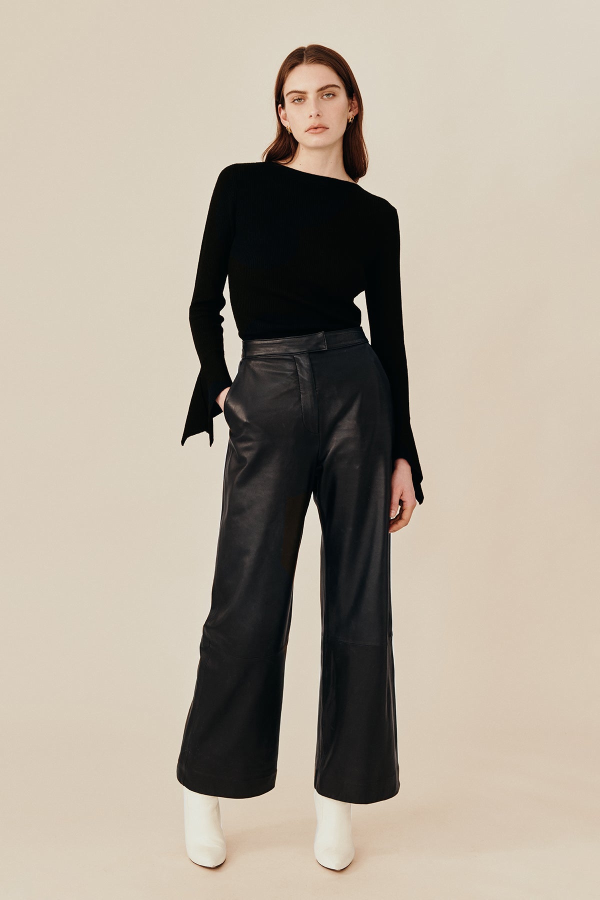 Model wearing Australian fashion designer Ginger & Smarts’ Genesis Leather Pant in a classic straight leg cut in luxe black leather worn with the black wool Dimension Knit Top.