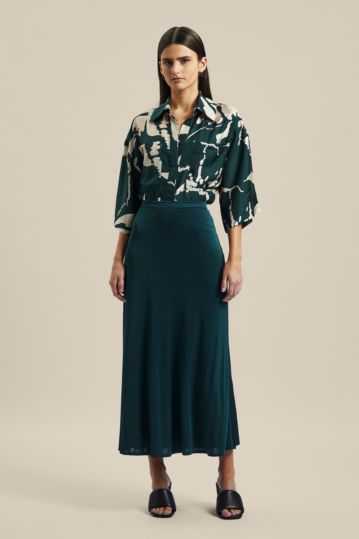 Model wearing the forest green silk Coalesce Skirt from Australian fashion designer Ginger & Smart. Worn with the Memoirs Blouse