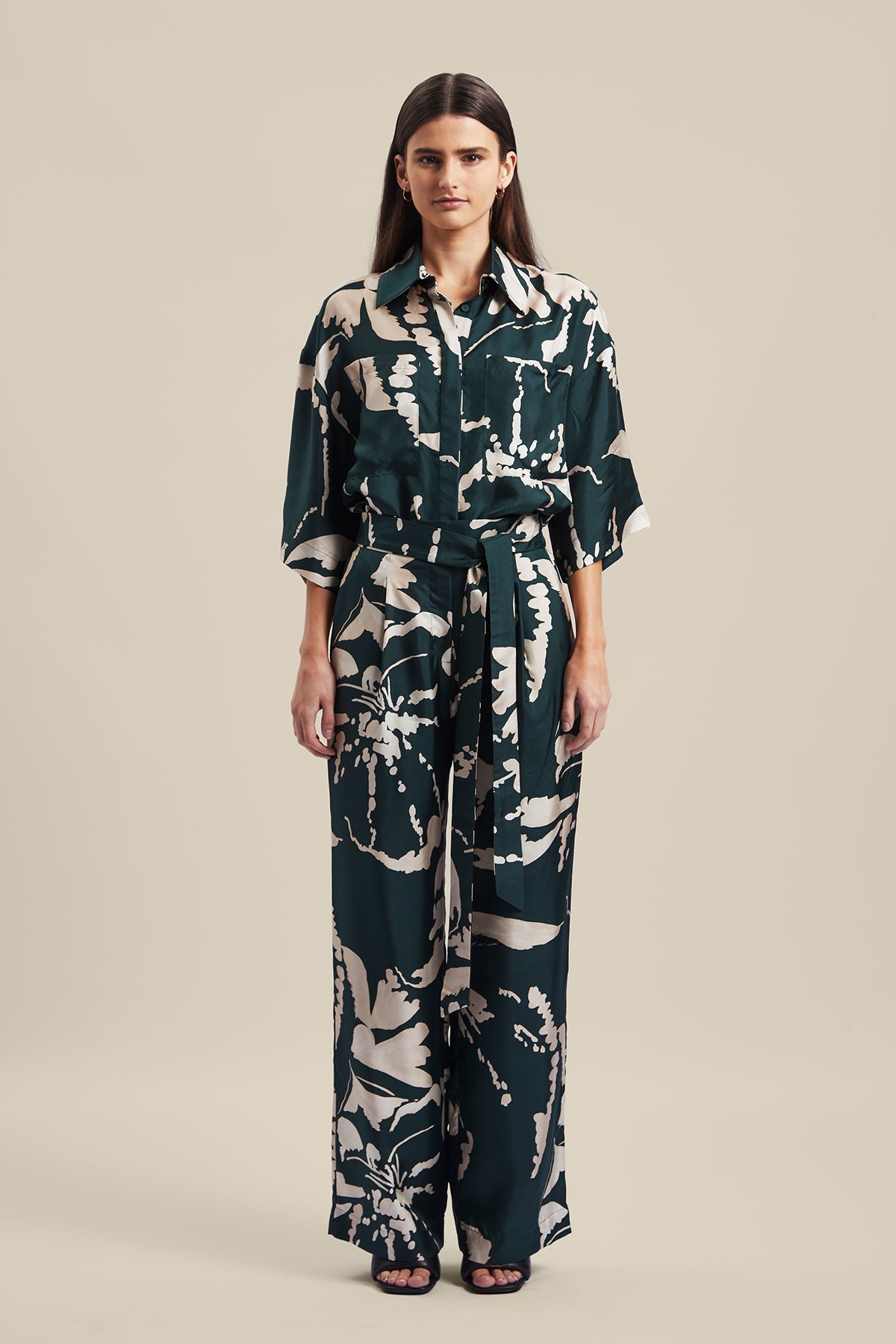 Model wearing the Memoirs Pant from Australian Fashion Designer Ginger and Smart featuring is an abstract floral in green and crème with elastic waist and drawstring detail. Worn with the matching Memoirs Blouse.