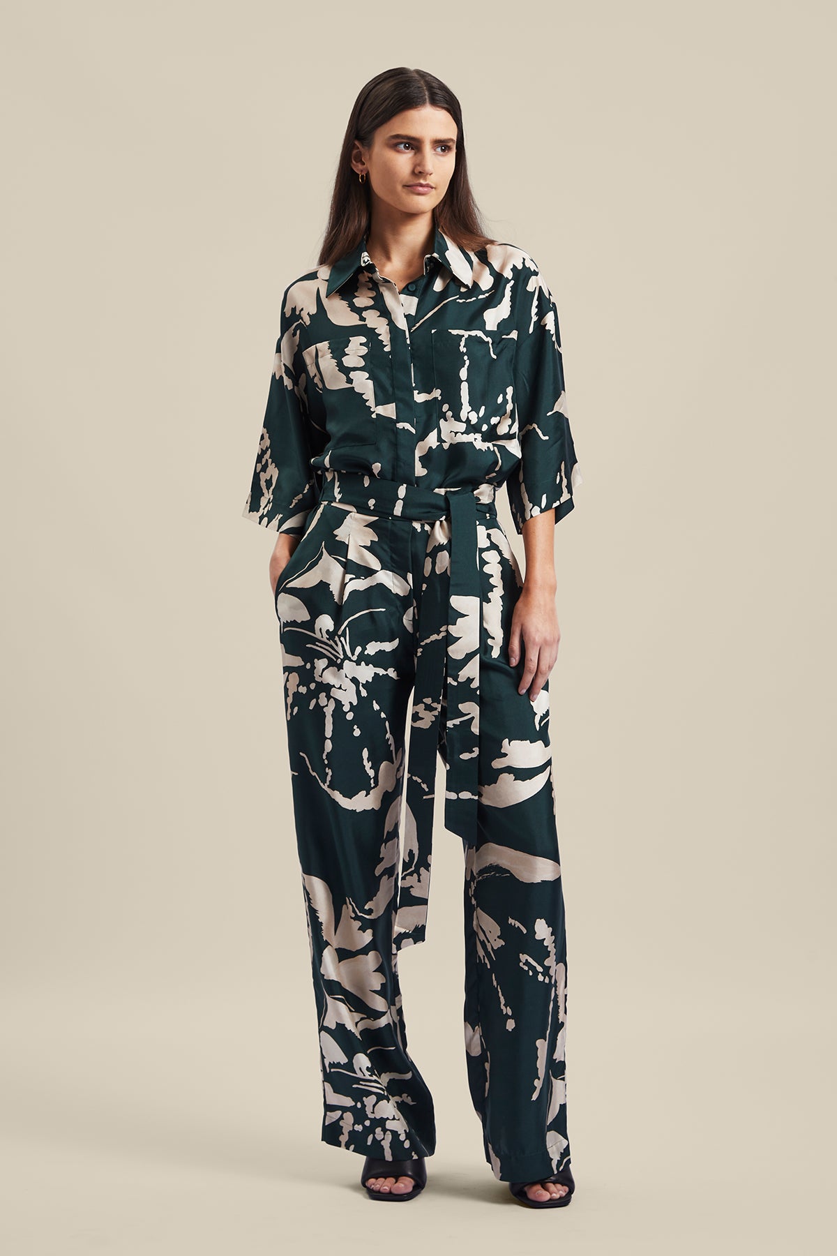 Model wearing the Memoirs Pant from Australian Fashion Designer Ginger and Smart featuring is an abstract floral in green and crème with elastic waist and drawstring detail. Worn with the matching Memoirs Blouse.