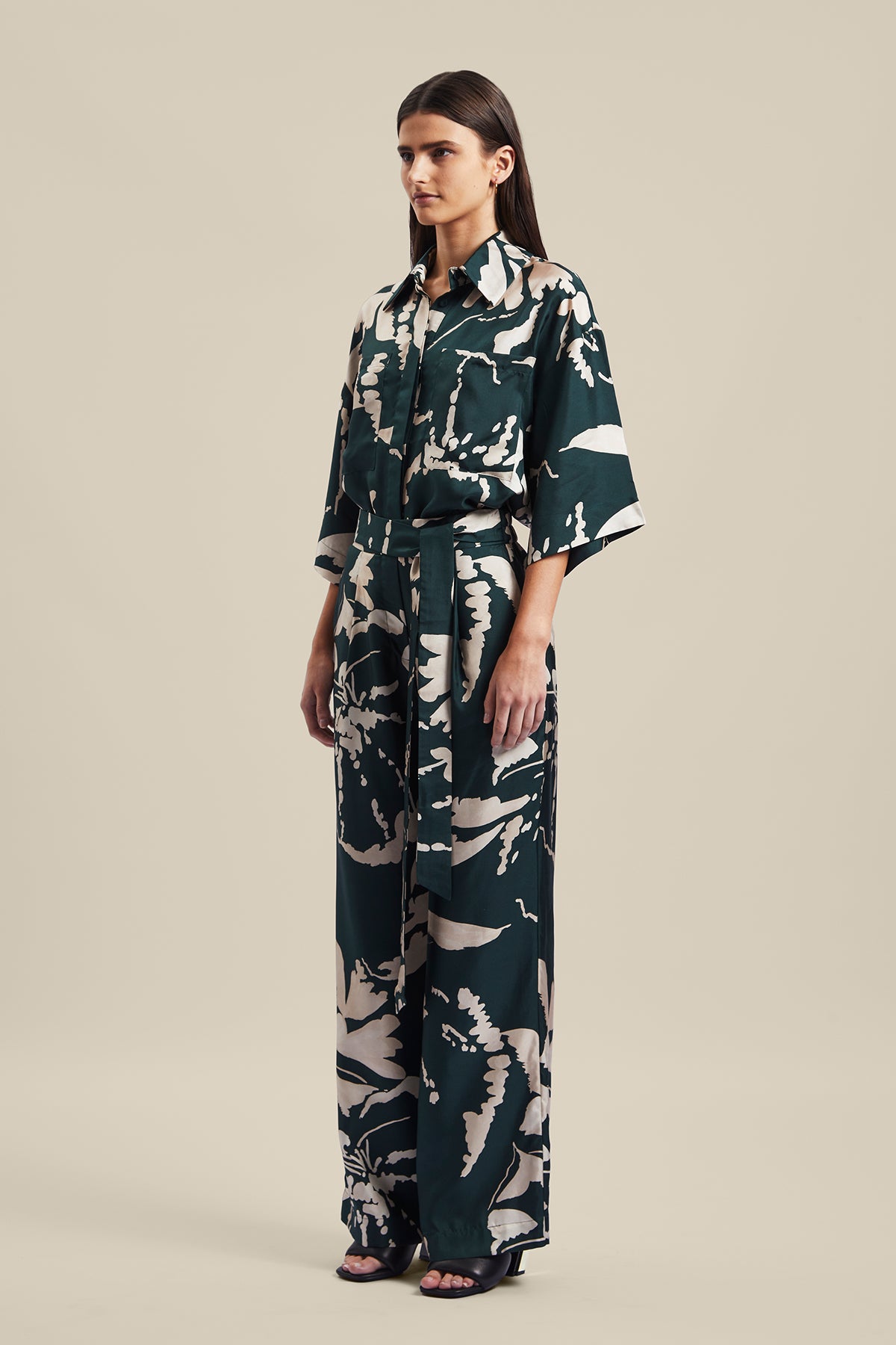 Model wearing the Memoirs Pant from Australian Fashion Designer Ginger and Smart featuring is an abstract floral in green and crème with elastic waist and drawstring detail. Worn with the matching Memoirs Blouse.