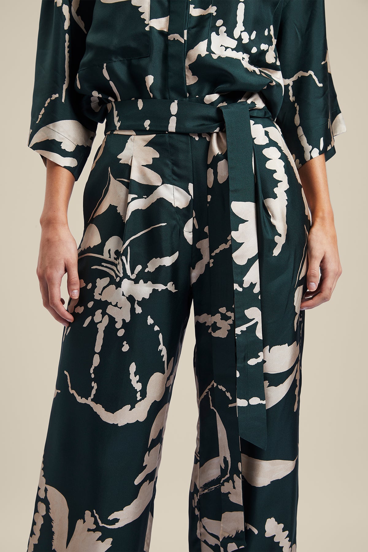 Model wearing the Memoirs Pant from Australian Fashion Designer Ginger and Smart featuring is an abstract floral in green and crème with elastic waist and drawstring detail. Worn with the matching Memoirs Blouse.