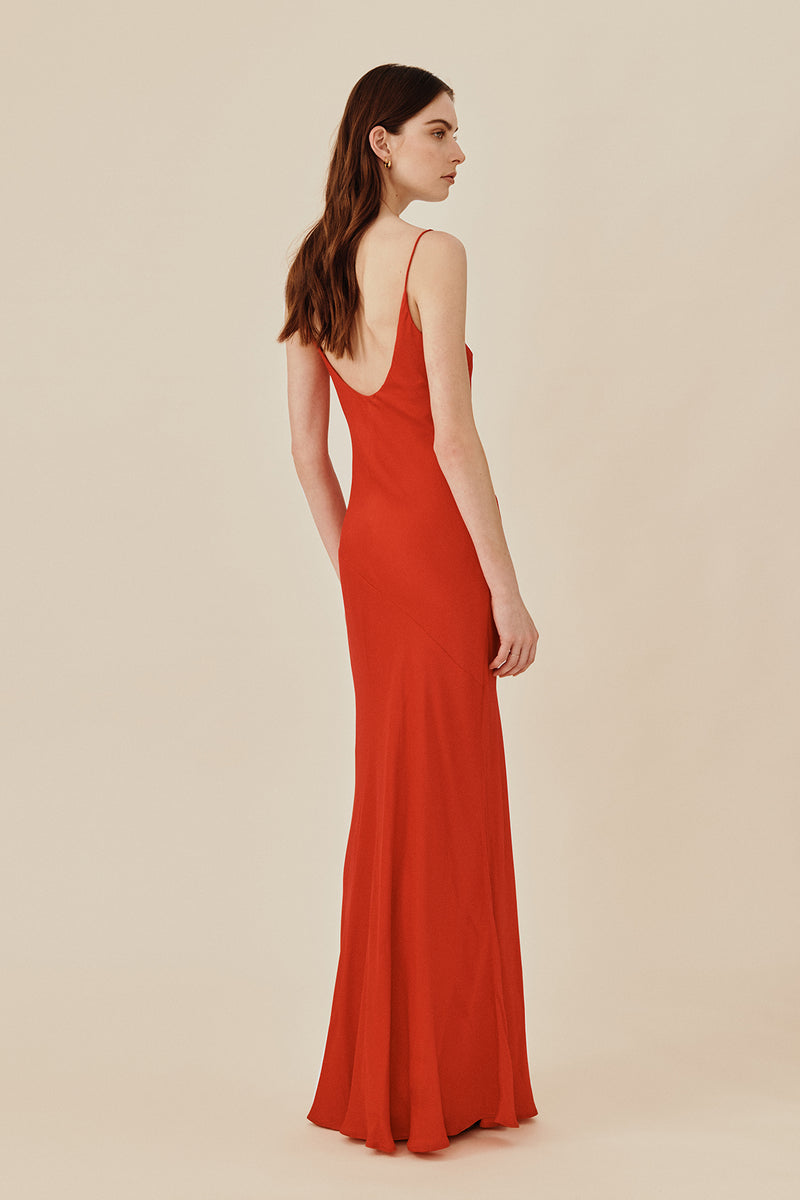 Back view of model wearing 90’s inspired red Nocturnal Slip Dress from Australian luxury women’s designer GINGER & SMART, featuring body skimming fit, spaghetti straps, scoop neckline detail, maxi length, and a bias-cut skirt.