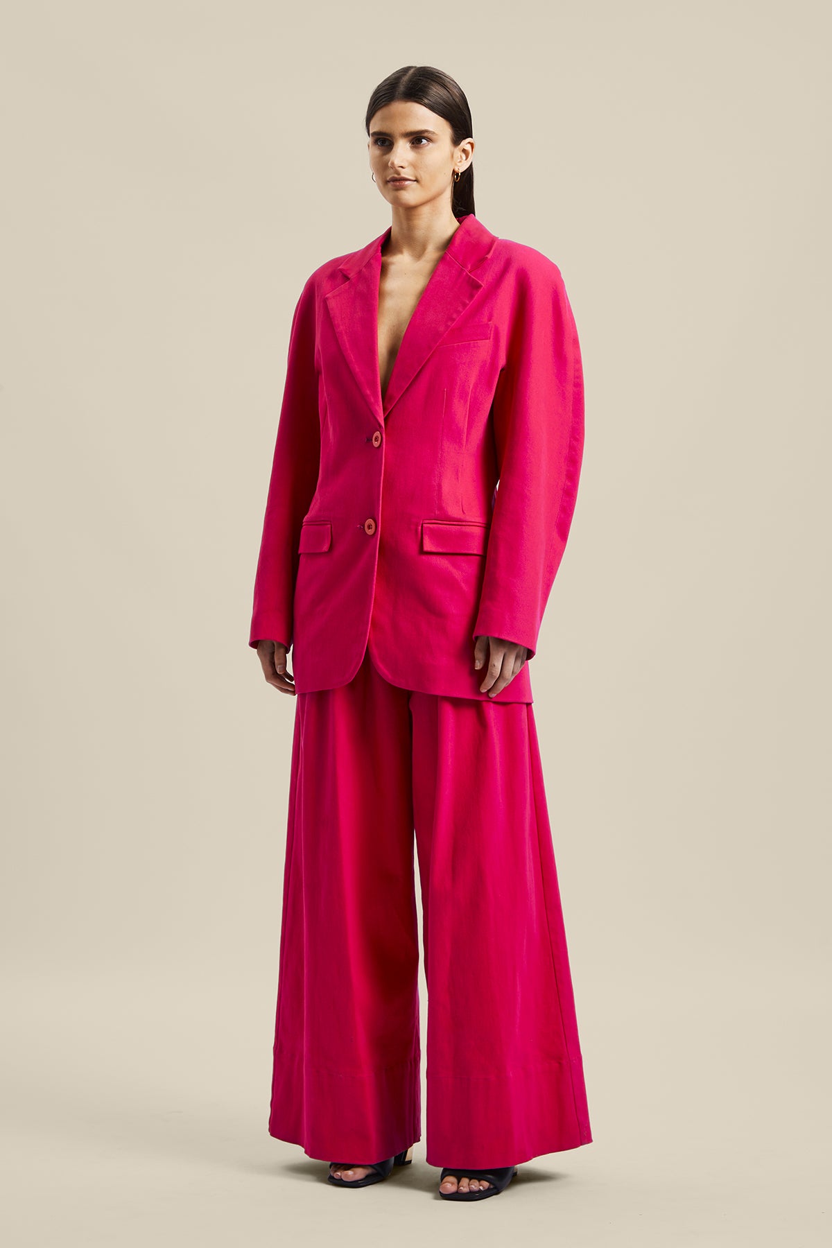 Model wearing the pink Novelist Jacket from Australian fashion designer GINGER & SMART featuring, tailored structural cut and oversized shape. Worn with the pink Novelist Pant.